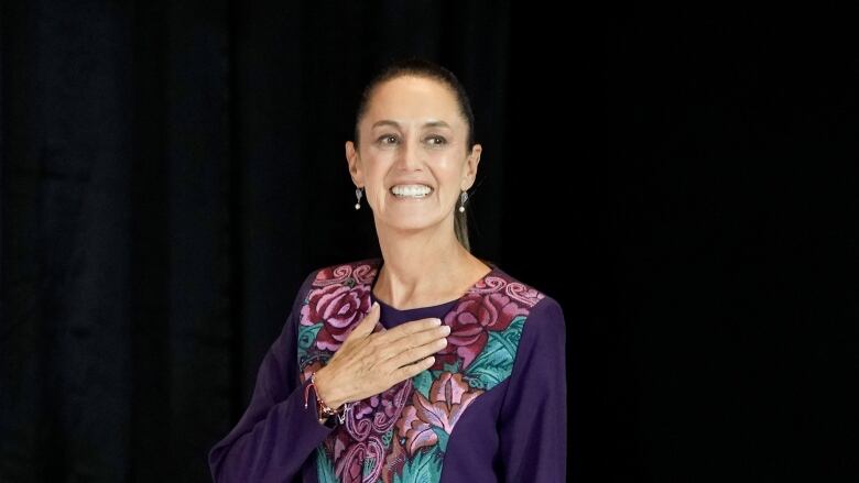 Ruling party presidential candidate Claudia Sheinbaum waves as she arrives to address supporters after the polls closed during general elections in Mexico City in Mexico City, early Monday, June 3, 2024.