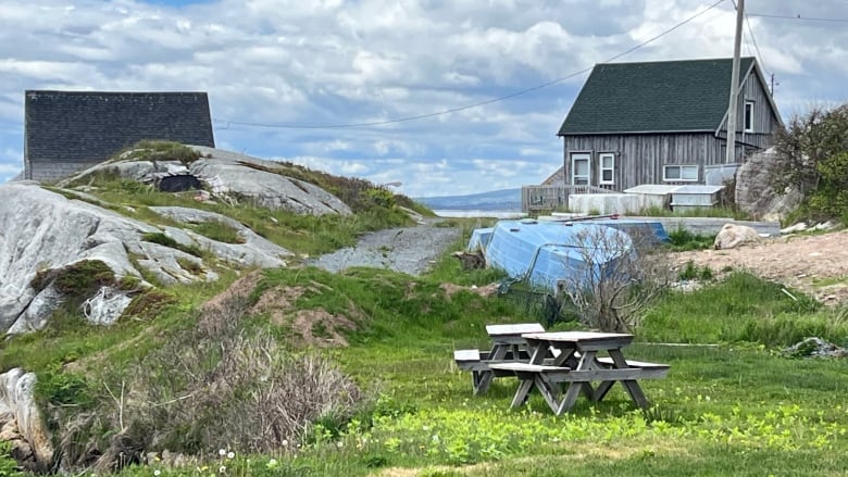 A grassy mound of dirt is shown at was once the entrance to Lobster Lane in Peggys Cove. 