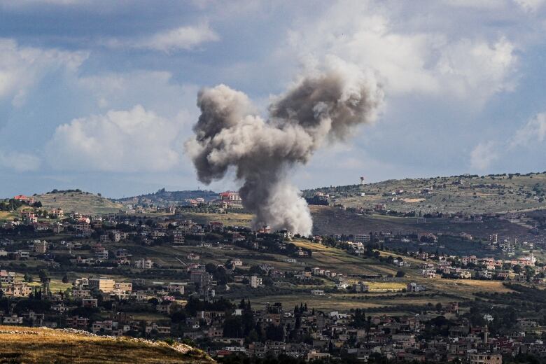 Smoke rises above Lebanon, following an Israeli strike, amid ongoing cross-border hostilities between Hezbollah and Israeli forces, as seen from Israel's border with Lebanon in northern Israel, May 5, 2024.