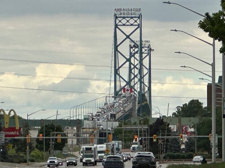 Trucks lined up along a bridge