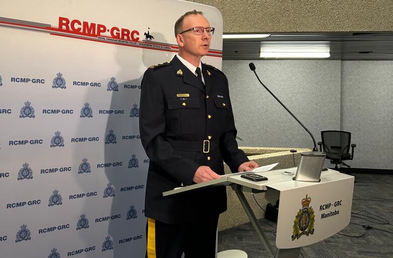 A police officer stands at a podium.