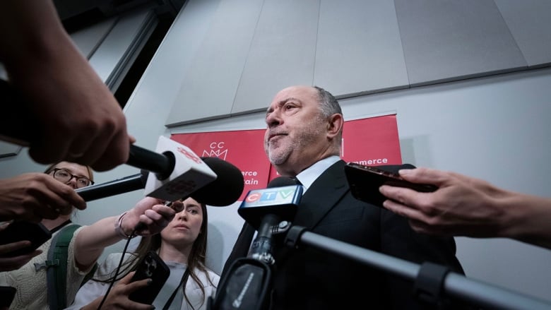 man speaking to reporters