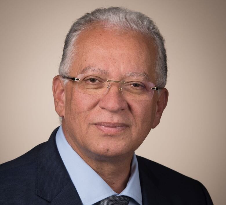 Head shot of a middle-aged  man with salt and pepper hair and glasses.