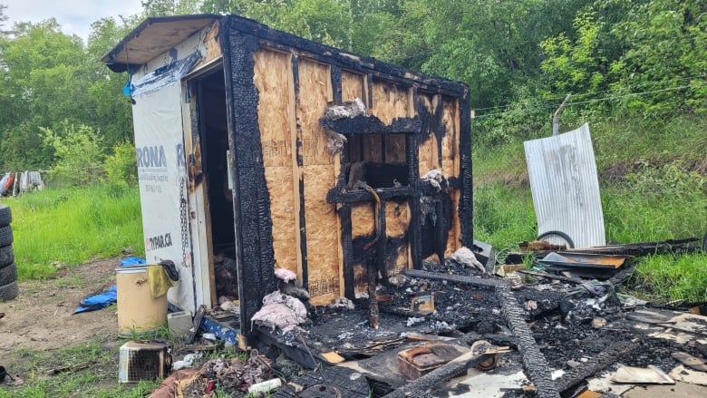 A burned-out tiny home shelter.