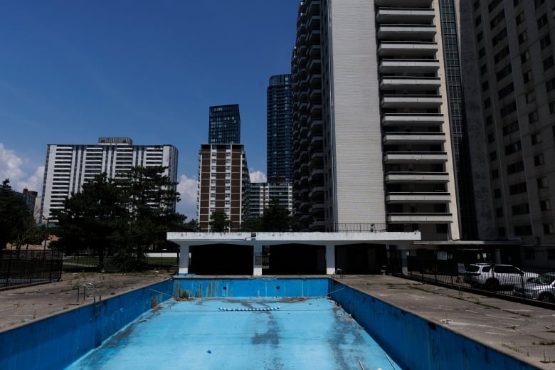 An empty pool is seen outside an apartment tower in St. James Town in Toronto, July 5, 2023.