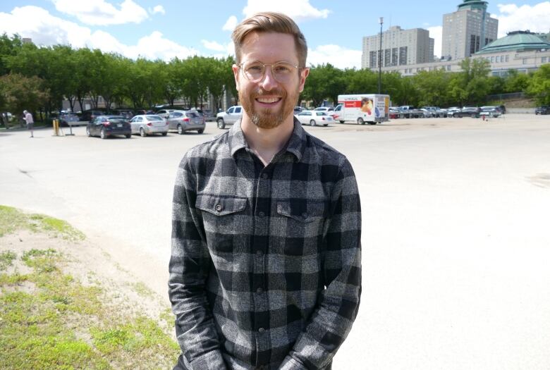 A man smiles at the camera