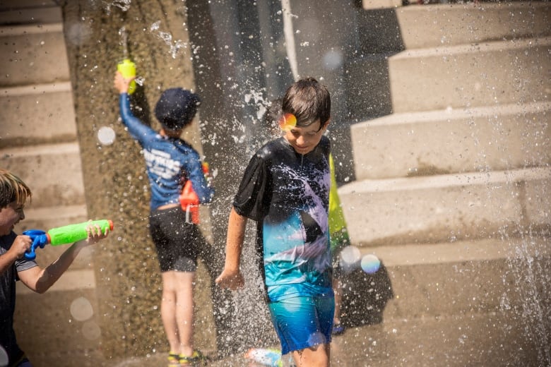 Andrej, 10, plays at a spray park in Vancouver, British Columbia on Monday, June 28, 2021.