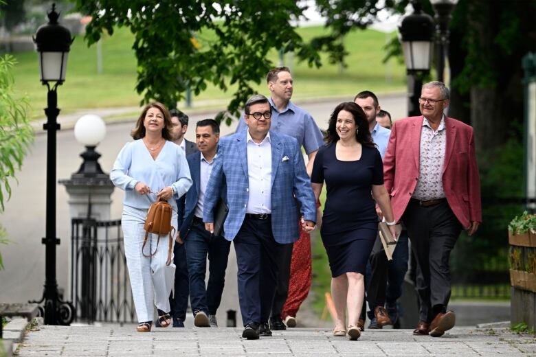 A politician and a group of people walking. 