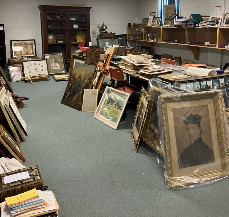 A room filled with lots of old paintings and artifacts 