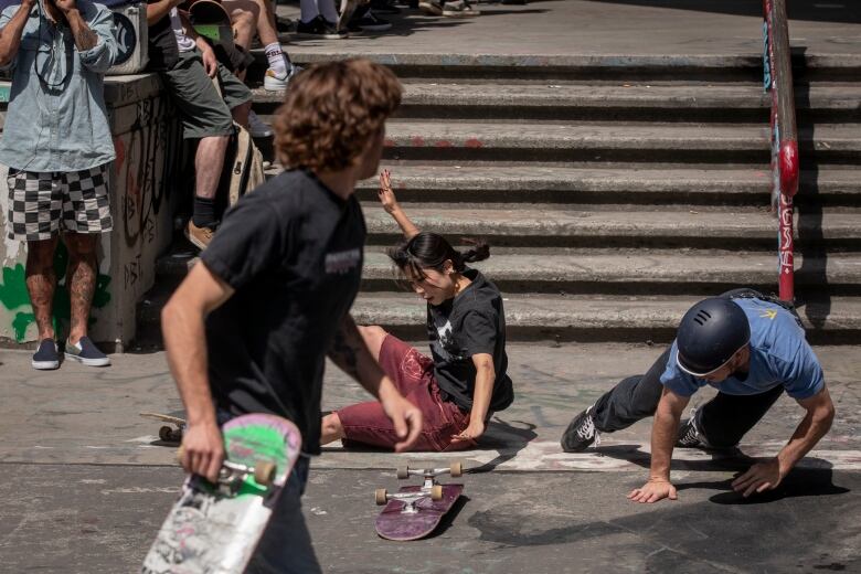 A skateboarder hits the ground.