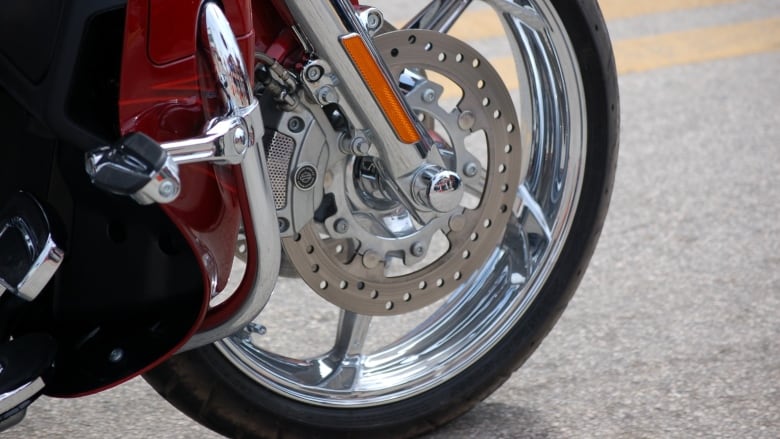 A closeup of a motorcycle front wheel.