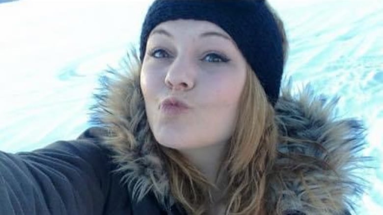 Young woman in parka in the snow.