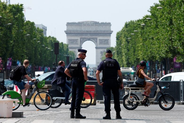 French CRS riot police patrol on the Champs-Elysees avenue near the Arc de Triomphe in Paris, France, June 27, 2024. 