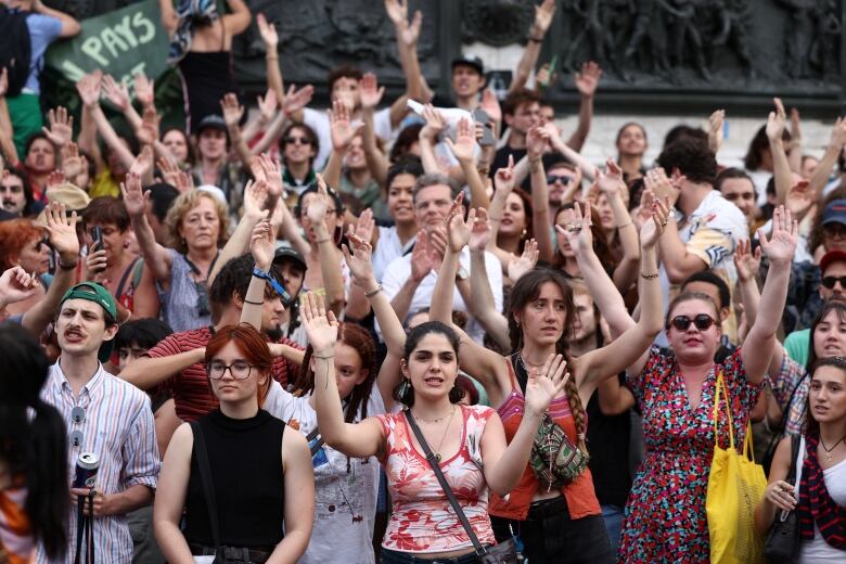 People attend a rally protesting against the French far-right Rassemblement National (National Rally - RN) party, launched at the initiative of independent media organisations, co-organized by labour unions and civil society associations, at the Place de la Republique in Paris, France, June 27, 2024. 