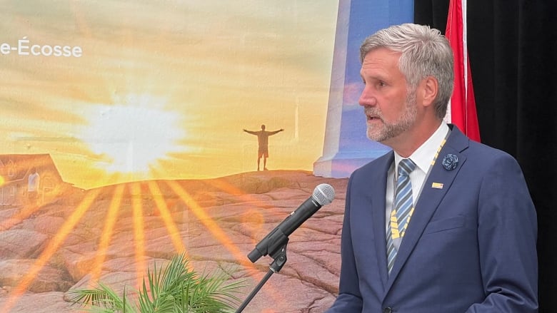 A man speaks at a podium