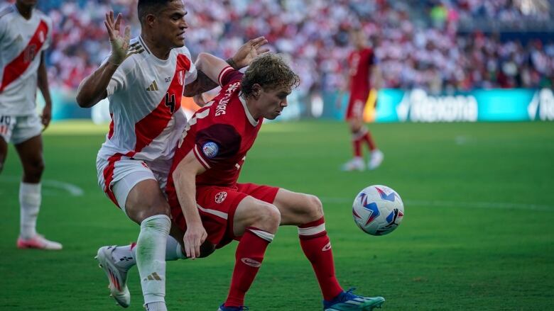 Canada's Jacob Shaffelburg dribbles past Peru's Andy Polo during a Copa America Group A soccer match in Kansas City on Tuesday.