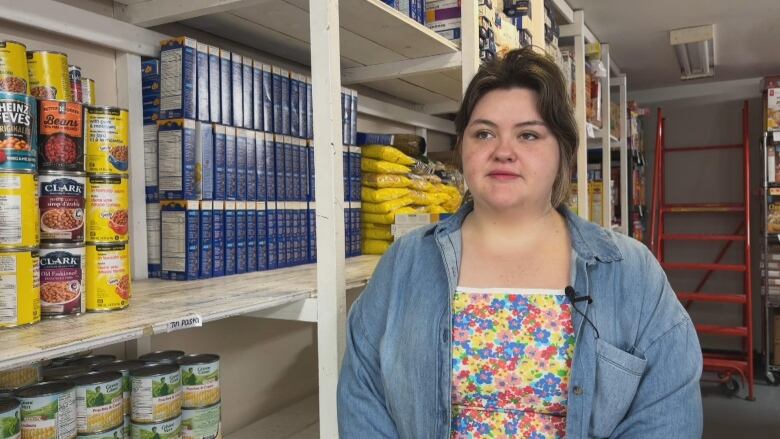 woman standing next to shelves containing food