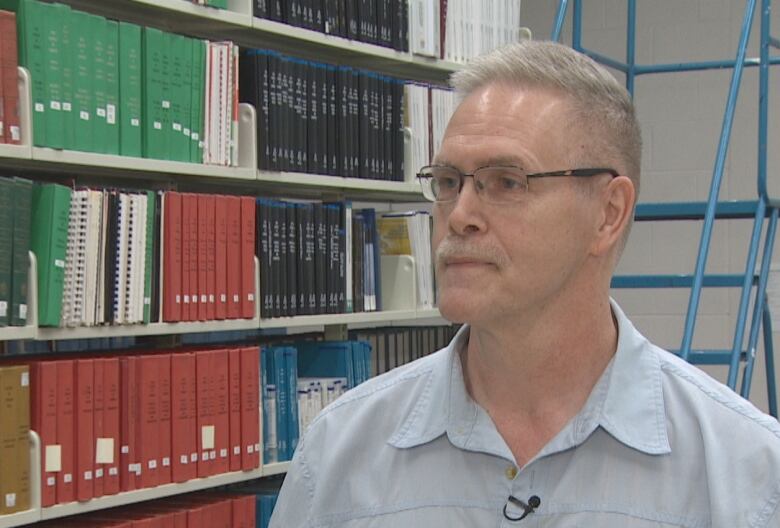 a portrait style photo of a man wearing glasses and closely cropped hair named David Mercer