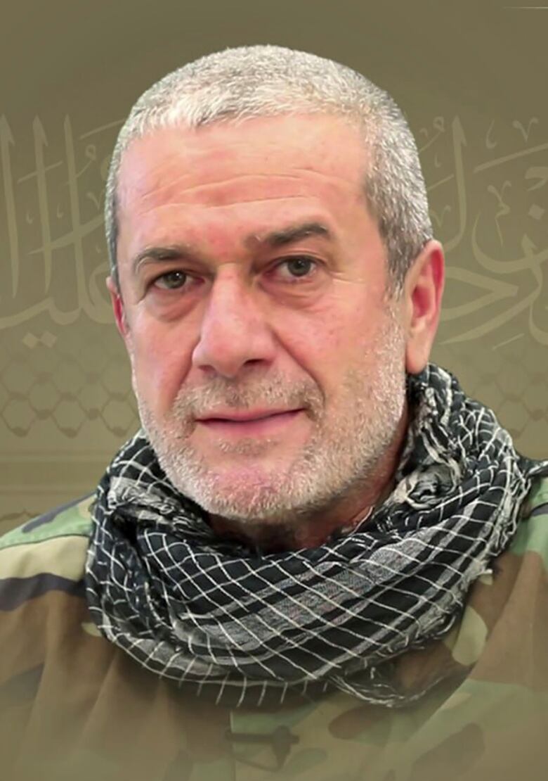 A man with short white hair and a trimmed white beard appears in military uniform in a formal photo.