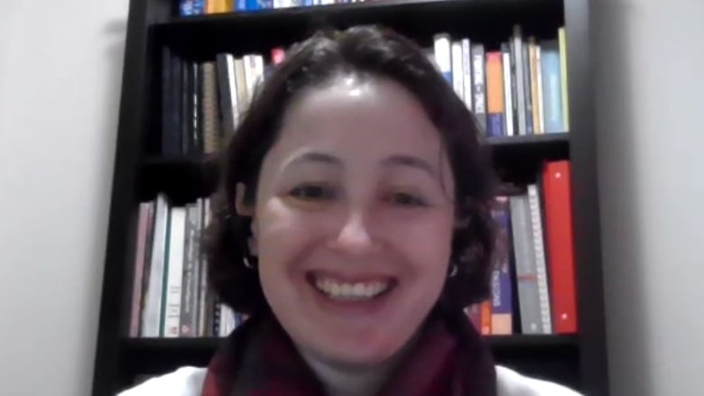 Headshot of Cecilia Sierra-Heredia sitting in front of a bookcase.