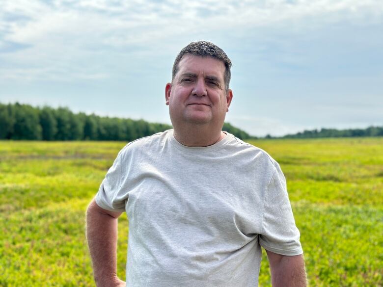 Man in front of blueberry field