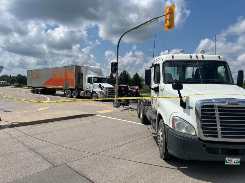 Passenger vehicles and two semi-trucks crashed at an intersection. 