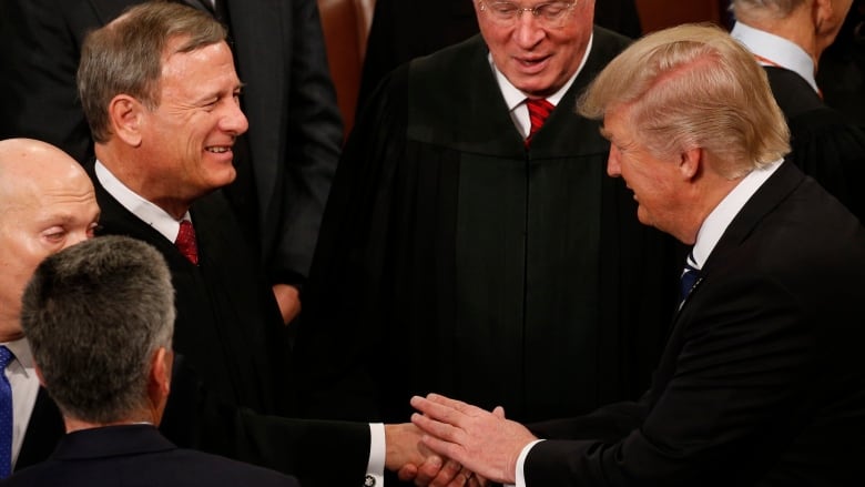 Roberts shakes Trump's hand amid crowd on floor of the US House of Representatives