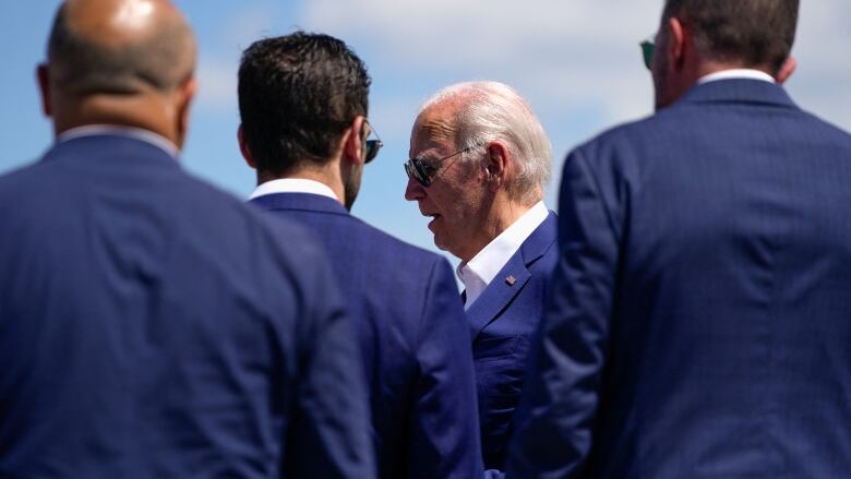 Biden surrounded by handlers