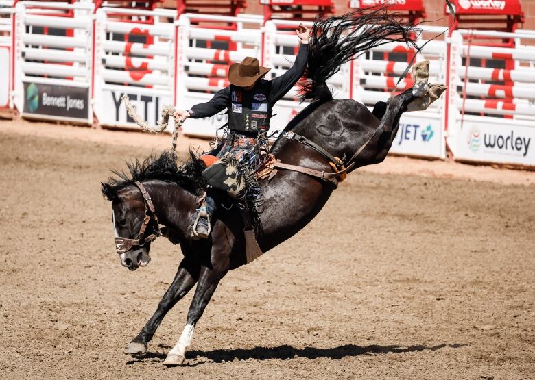 A cowboy rides a horse. 