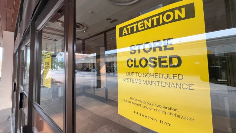 A sign at the glass doors at a Hudson's Bay store the retail outle is closed 