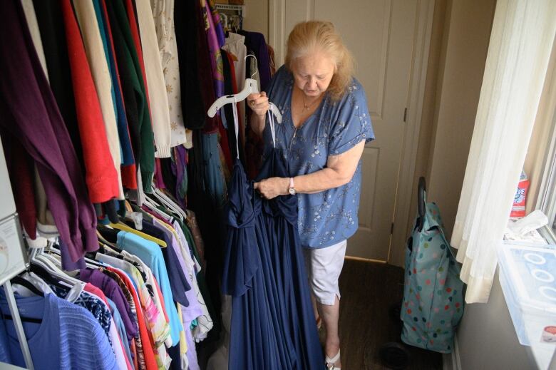 Suzanne Scott shows off her wedding dress in her walk-in closet, which now features a doorway, located behind the camera, connecting her unit to her soon-to-be husband's.