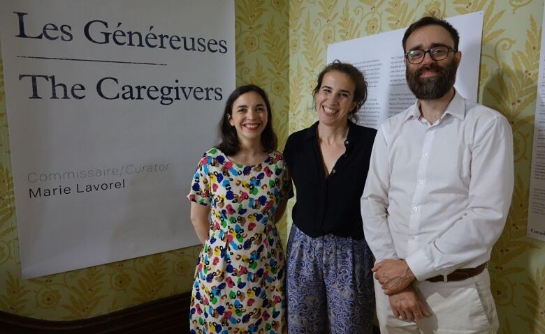 Three people pose for a photo.