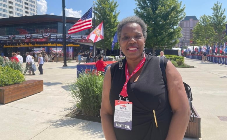 Woman with lanyards outside building