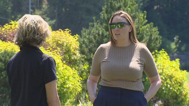 Parent Katie Thompson raises her concerns about the possible school closure to Cathy Jewett outside the Spruce Grove field house.