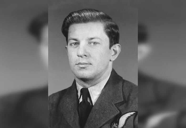 Black and white photo of a man in a military uniform. He is seen from the shoulders up.