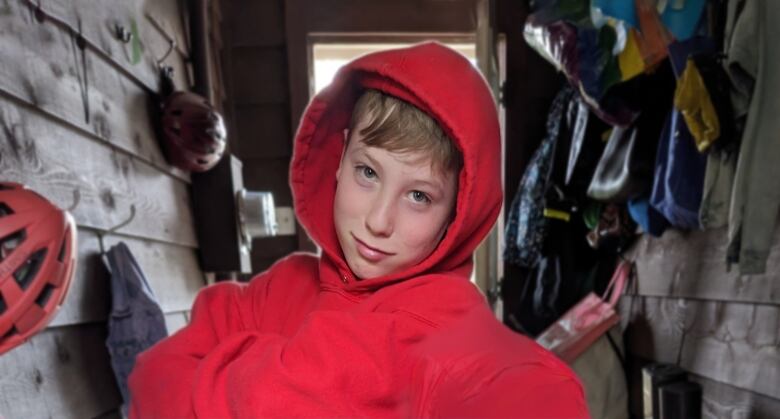 A boy with wears a red hoodie