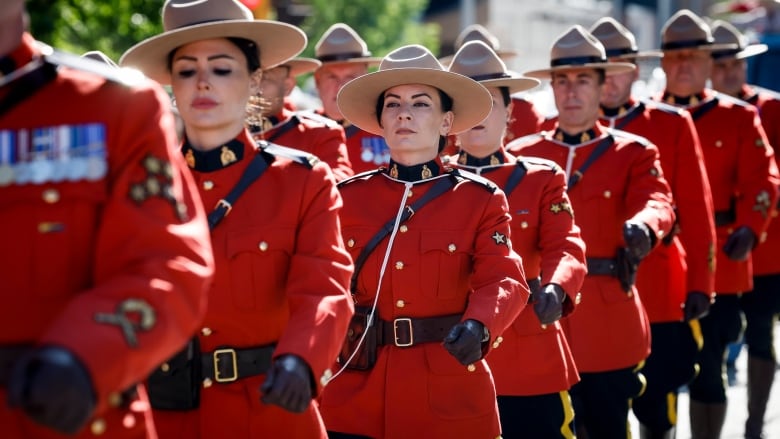 Members of the RCMP march during the Calgary Stampede parade in Calgary, Friday, July 5, 2024.