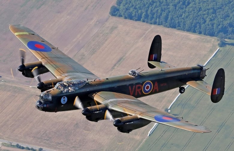 A large military plane with gunner turrets flies across the Prairie.