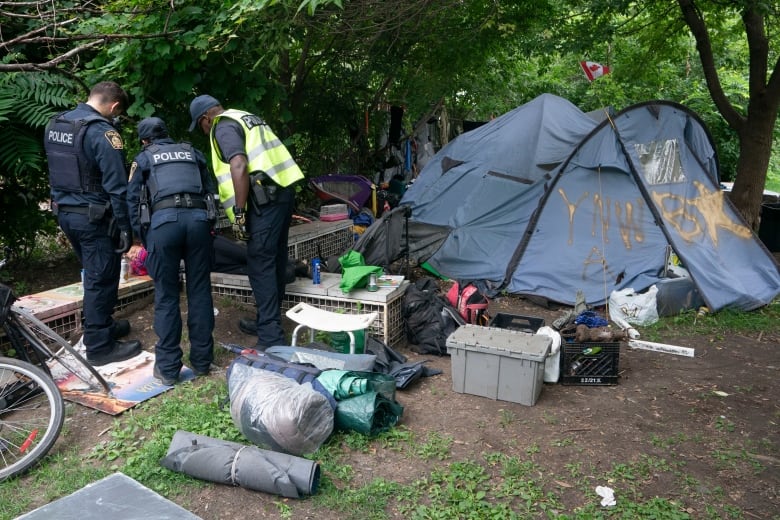 police dismantling a homeless encampment