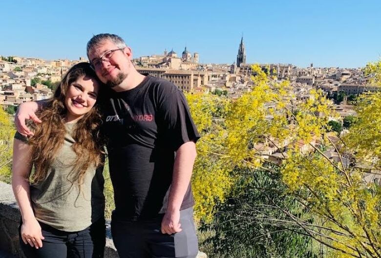 Two people take a picture on a hill.