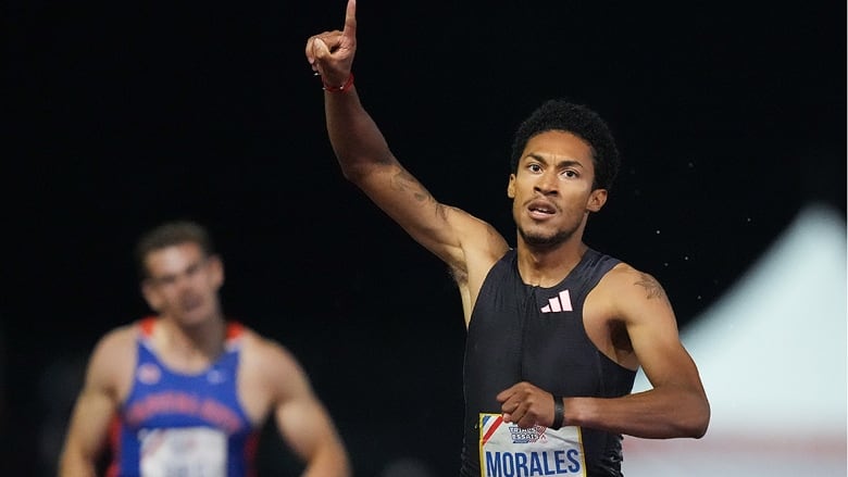 Christopher Morales-Williams points his right index finger to the sky while raising his arm as he crosses the finish line in the men's 400 metres at the Canadian Olympic trials in Montreal on June 29, 2024. 