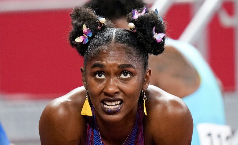 A woman with dangly earrings and hair clips