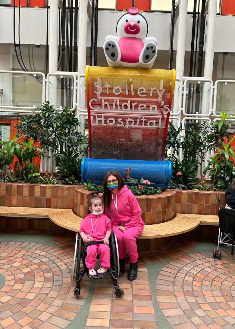 A mother and daughter in pink.