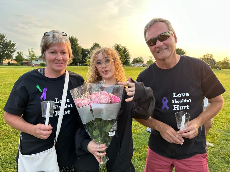 Heather Trevithick and Joe Quigg stand with Broadfoot's friend Tavia Lapier, middle, wearing T-shirts that say 