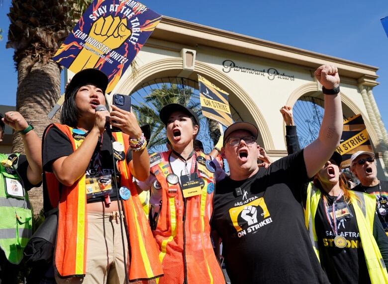 People stand outside paramount pictures office striking