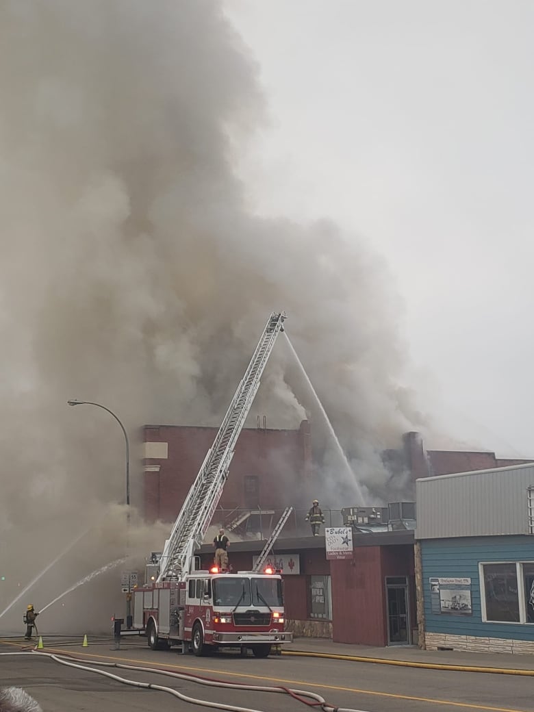 Fire truck putting out fire. 