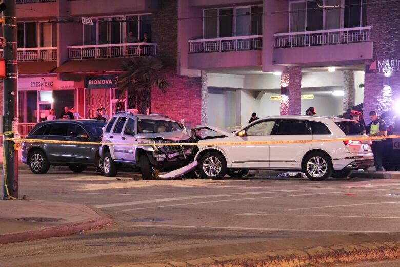 Three cars are pictured piled into each other on a large street.