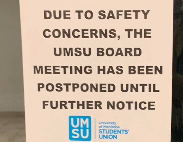 A sign which says 'Due to safety concerns, the UMSU board meeting has been postponed until further notice.'