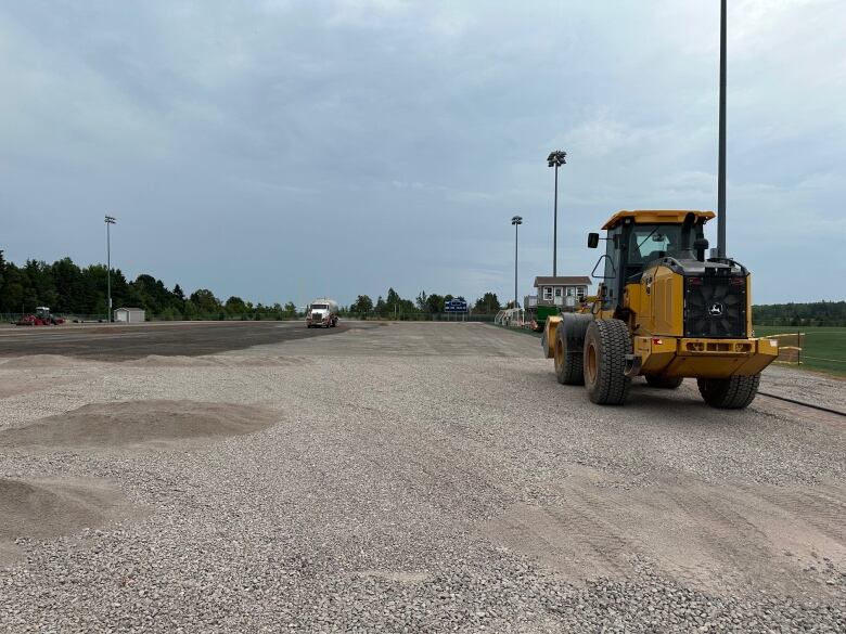 A truck drives on the field.