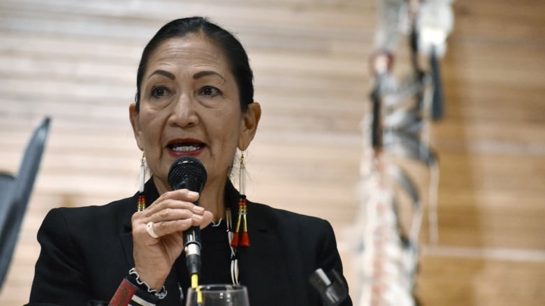 Deb Haaland speaks into a microphone